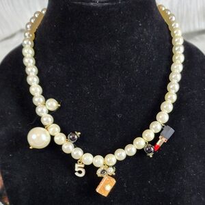 Elegant Pearl Necklace with Gold and Black Charms